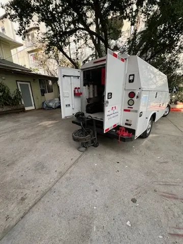Magnet Plumbing service vehicle on-site for Grease Trap Cleaning in Alamo Heights